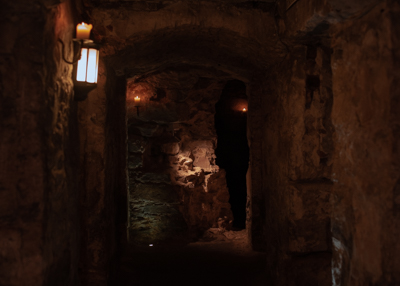 A corridor of the Blair Street Underground Vaults lit by candles