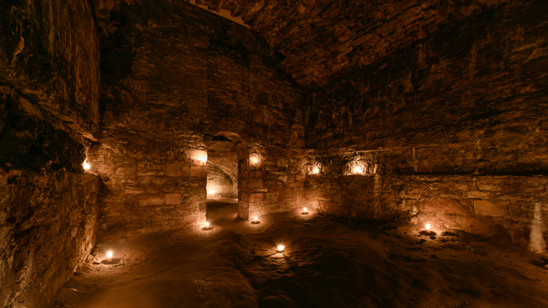 A tall room in the Blair Street Underground Vaults in Edinburgh on a Halloween underground ghost tour.