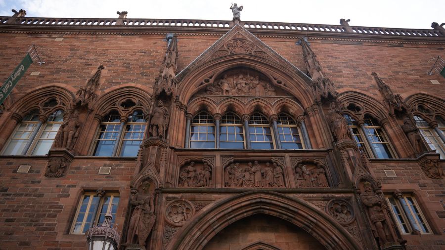 The front of the Scottish National Portrait Gallery, a neo-Gothic building carved out of red sandstone blocks. 