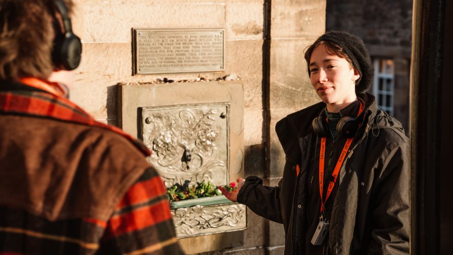 A Mercat Storyteller showing the Edinburgh Witches Well to a guest during a Witches: Trial and Truth tour. 