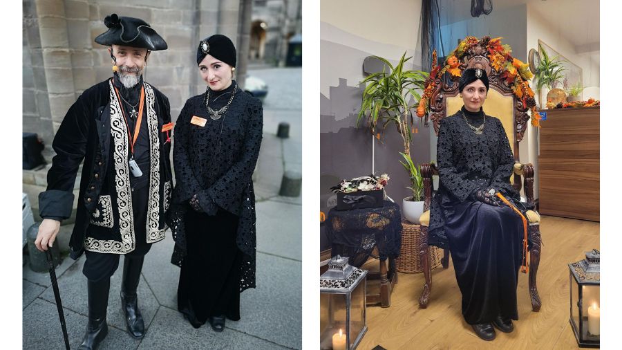 Two Mercat Storytellers dressed in black costumes, one in 17th century men’s dress, the other dressed as a Victorian medium or oracle.