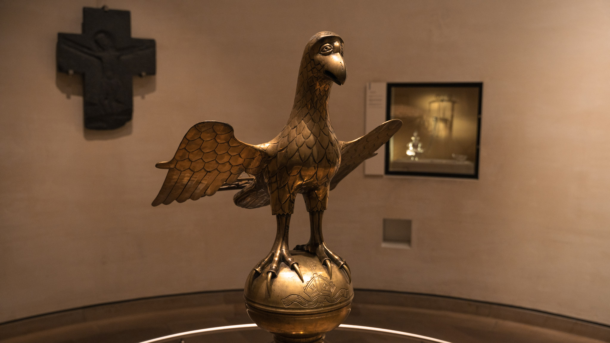 A brass book stand in the shape of an eagle with very large eyes, on display at a history museum in Edinburgh. 