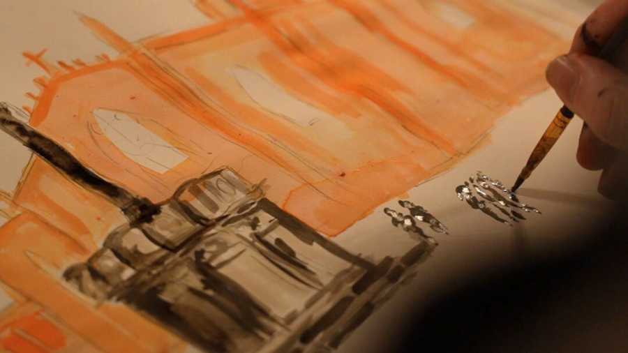 A close-up of a hand painting the silhouettes of people near the Edinburgh Mercat Cross using dark ink, with St Giles Cathedral painting in orange water colours in the background.