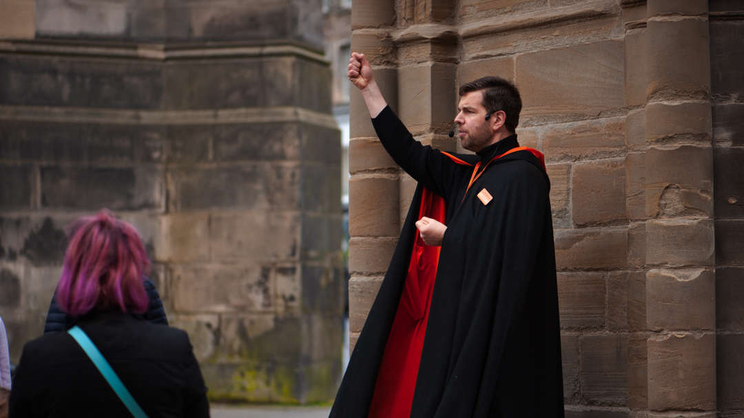 A Mercat Storyteller telling a story at the Edinburgh Mercat Cross. 